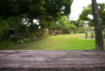 Fototapeta premium Empty wooden table in front of abstract blurred background of coffee shop . can be used for display Mock up of product