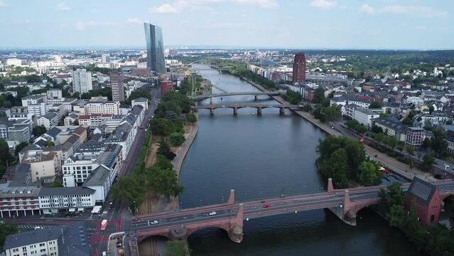 Above a section of the river Main flowing through Frankfurt, where the Floesser bridge, the Ignatz-Bubis bridge, and the old bridge can be seen.