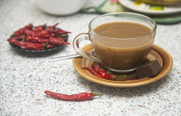cup of hot coffee with chili peppers and spices