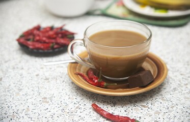 cup of coffee with chocolate and red chili peppers