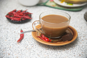 cup of tea and a hot chili pepper on the table