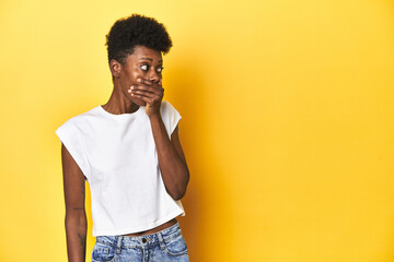 Elegant African woman, short hair, white tank top, Elegant African woman, short hair, white tank topthoughtful looking to a copy space covering mouth with hand.