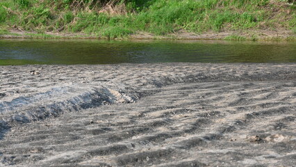 view of a dried up river, sand of a dried up river, drought, abnormal heat, dried up lake 