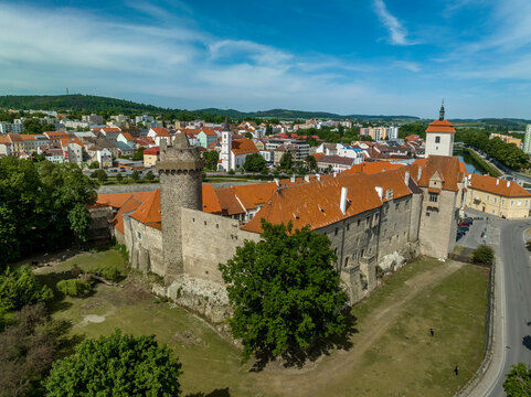 Aerial view of Strakonice castle next to the Otava river in Czechia with Gothic, Baroque palace and restored circular donjon with edge called Rumpal tower