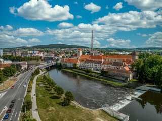 Naklejka premium Aerial view of Strakonice castle next to the Otava river in Czechia with Gothic, Baroque palace and restored circular donjon with edge called Rumpal tower