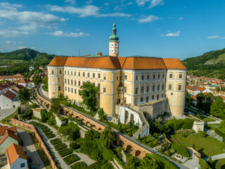 Obraz premium Aerial view of restored Baroque Mikulov castle in Southern Bohemia also called Nikolsburg with medieval towers surrounded by communist style houses