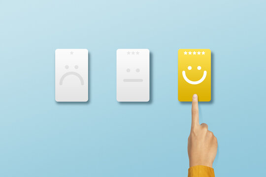 Customer choose smile emoticon with five star for rating. Service rating, feedback, satisfaction concept
