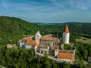Naklejka na ściany i meble Aerial view of triangular shape restored Gothic medieval castle Krivoklat in Central Bohemia Czech Republic with concentric keep