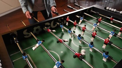 People play table football in a cafe. Close-up - Powered by Adobe