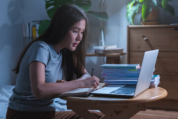 Wfh, asian young student woman making notes, study online of university, sitting on desk at home,...