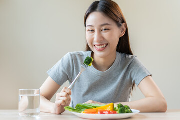 Obraz na płótnie Canvas Diet, Dieting asian young woman or girl use fork at broccoli on mix vegetables, green salad bowl, eat food is low fat good health. Nutritionist female, Weight loss for healthy person.