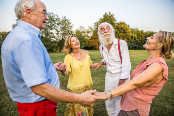 Group of senior people bonding outdoors - Happy olpd people having fun in a park, concepts about...