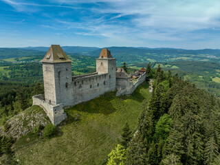 Naklejka premium Aerial view of Kasperk Hrad or Karlsberg castle in Czechia. The central part of the castle consists of two residential towers and an oblong palace which was built between them