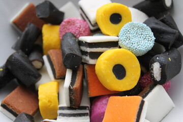 Different all sorts liquorish sweets in a pile with different shapes, sizes and colors