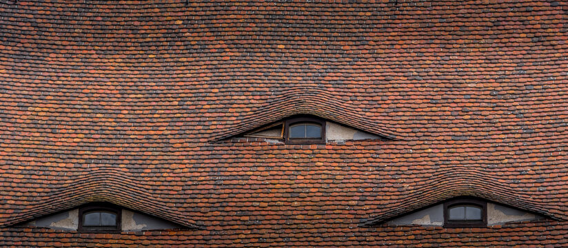 Triple eyebrow dormer window on the roof of a baroque house in Gorlitz ventilation system for the houses' attics