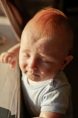 close-up portrait of baby, 10 months old, sweet baby boy, red hair
