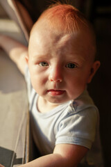 close-up portrait of baby, 10 months old, sweet baby boy, red hair