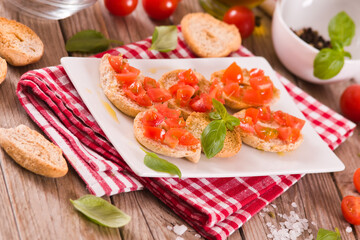 Fototapeta na wymiar Friselle with cherry tomatoes and basil.