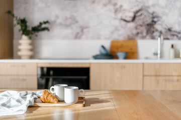 dining wood table with coffee in mugs and homemade sweet pastry
