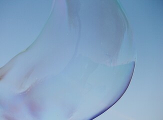 Soap bubbles on a blue sky illuminated abstract background with copy space 
