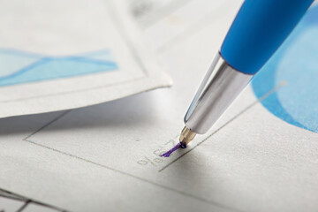 Accounting document with pen, money, coins and checking financial chart. Concept of banking,...