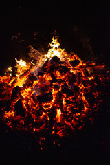 Fototapeta na wymiar A pile of wood burning in a fire, on the night of the summer solstice