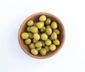Olive in the wooden bowl on the white background. Top view. Close-up.