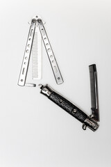 Stainless steel folding butterfly comb on white background isolated