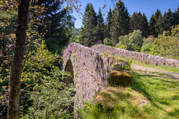 A bright summer, HDR landscape image, of the General George Wade bridge crossing the River Fechlin at Whitebridge,Stratherrick, Scotland. 04 June 2023