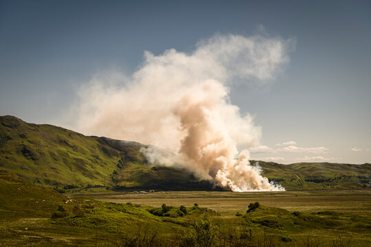 A summer HDR image of stubble being burnt off in a field during a very hot and dry period of weather in South Morar, Scotland. 5th June 2023