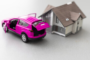 Car and House model with agent and customer discussing for contract to buy, get insurance or loan real estate or property background.