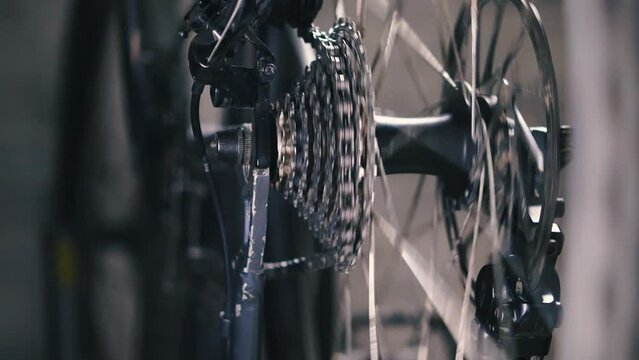 Process of changing gears on the rear derailleur of a mountain bike. Close-up of the cassette and bike chain. Setting up and servicing your bike's driveline. Slow motion