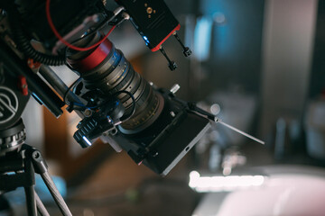 Professional cinema and video camera on the set. Shooting shift, lighting fixtures, shooting equipment and the team.