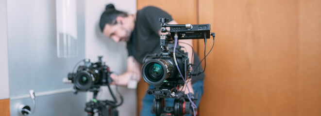 Professional cinema and video camera on the set. Shooting shift, lighting fixtures, shooting equipment and the team.