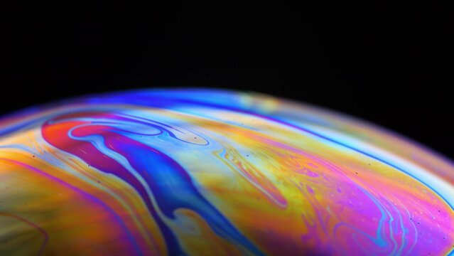 Rainbow multilayer film. Spherical abstraction of iridescent blue, yellow and red colors with soft focus. The natural environment.