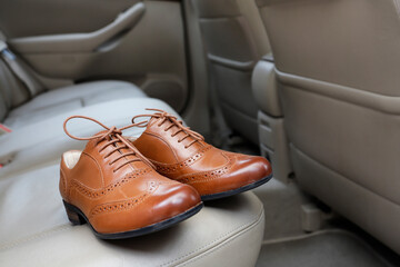 A pair of beautiful shoes on the car seat.