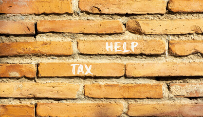 Tax help symbol. Concept words Tax help on beautiful brown bricks on a beautiful brick wall background. Business, support and tax help concept. Copy space.