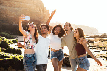 Happy millennial multiethnic people students enjoy summer holidays, have fun, taking selfie on phone - obrazy, fototapety, plakaty