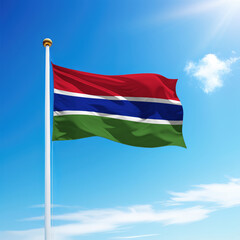Waving flag of Gambia on flagpole with sky background.