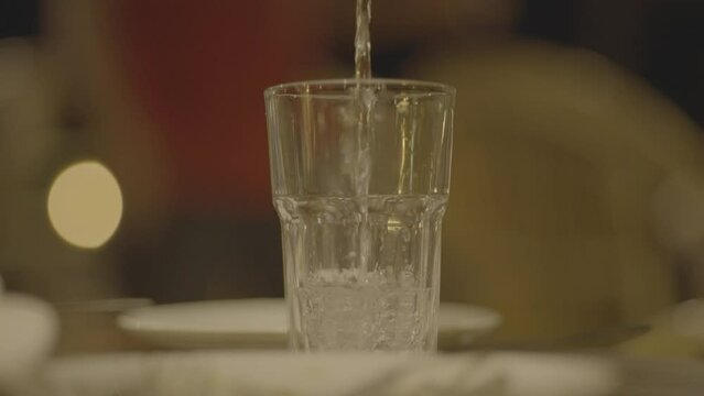 Slow motion 4k 120fps pouring glass of water a7siii stock raw footage