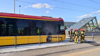 Firemen and burnt tram transport. Fire brigade action.