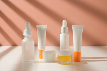 The skincare packaging set include jar, dropper bottle, and tube on sun shade background.