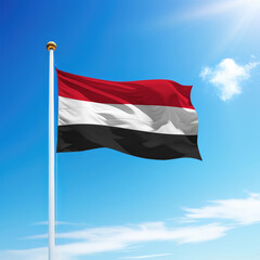 Waving flag of Yemen on flagpole with sky background.