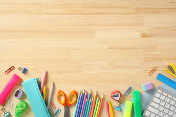 Frame of school supplies on wooden background. Back to school concept.