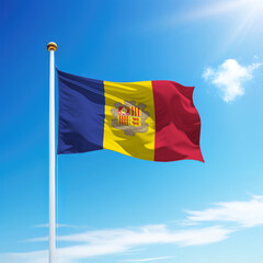 Waving flag of Andorra on flagpole with sky background.