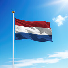 Waving flag of Netherlands on flagpole with sky background.