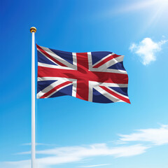 Waving flag of United Kingdom on flagpole with sky background.