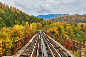 View on railway bridge above the Prut river. Beauteful autumn in Carpathian mountains, Ukraine