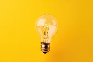glowing light bulb on a vibrant yellow background