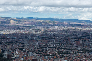 Fototapeta na wymiar Bogota colombia south zone cityscape viewed from eastern mountains with andean mountain range at background